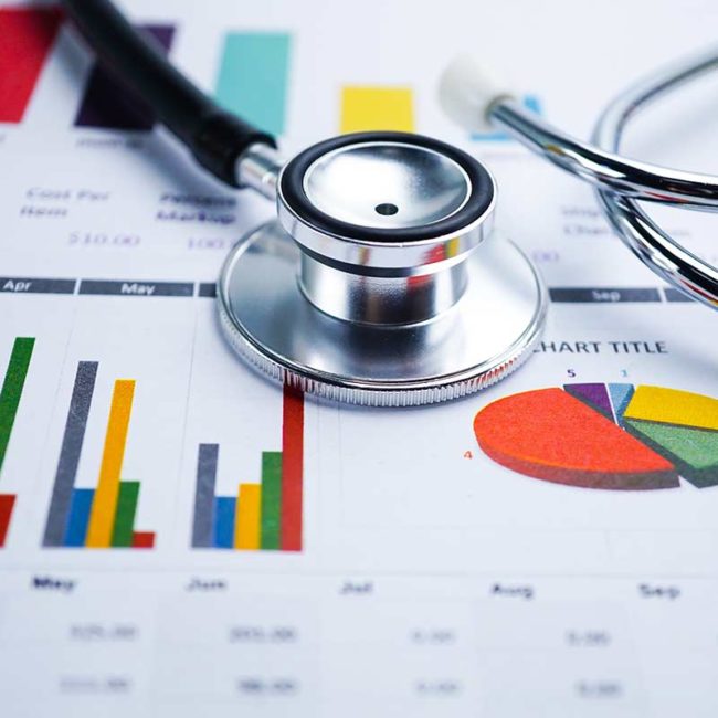 A stethoscope sitting on charts of marketing data