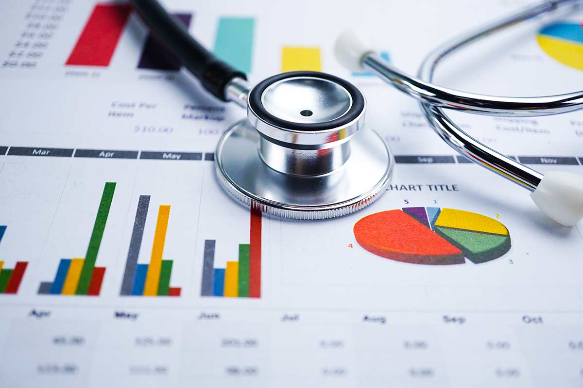 A stethoscope sitting on charts of marketing data